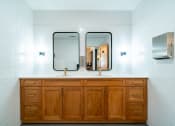 Thumbnail 19 of 44 - two mirrors on top of a bathroom counter with two sinks