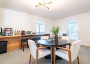 Thumbnail 35 of 44 - a dining room with a table and chairs and a kitchen