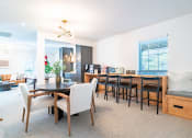 Thumbnail 34 of 44 - a living room and dining room with a table and chairs and a kitchen
