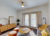 Thumbnail 1 of 22 - a living room with a couch and a mirror and a window