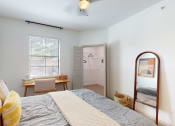 Thumbnail 7 of 22 - a bedroom with a bed and a mirror