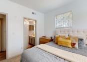 Thumbnail 10 of 22 - a bedroom with a bed and a bathroom