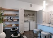 Thumbnail 11 of 47 - A kitchen with a black table and white appliances.