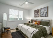 Thumbnail 4 of 22 - a bedroom with a bed and a ceiling fan