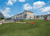 Thumbnail 25 of 28 - the preserve at ballantyne commons park with two dogs playing in the grass