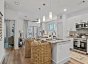 Thumbnail 44 of 47 - an open kitchen and living room with a table and chairs