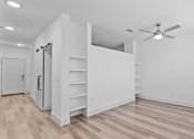Thumbnail 43 of 47 - an empty living room with white walls and a ceiling fan