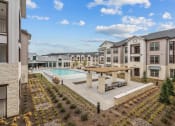 Thumbnail 11 of 47 - an apartment building with a pool and a courtyard