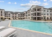 Thumbnail 8 of 47 - an empty pool with an apartment building in the background