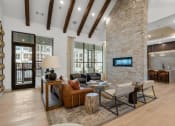 Thumbnail 17 of 47 - a large living room with a stone fireplace and a tv
