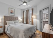 Thumbnail 42 of 47 - a bedroom with a bed and a ceiling fan