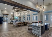 Thumbnail 20 of 24 - A modern kitchen with a large island and a dining area.