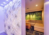 Thumbnail 16 of 35 - A room with a patterned wallpaper and a couch.