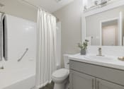 Thumbnail 4 of 29 - A bathroom with a toilet, sink, and shower.