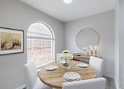 Thumbnail 6 of 29 - A dining room with a round table and chairs.
