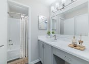 Thumbnail 11 of 29 - A white bathroom with a white sink and a white counter.