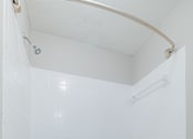 Thumbnail 37 of 61 - A white toilet sits next to a white bathtub in a bathroom.