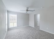 Thumbnail 18 of 61 - A room with a ceiling fan and a window with blinds.