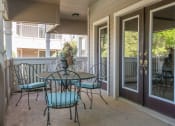 Thumbnail 10 of 21 - a patio with a table and chairs in front of a door