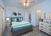 Thumbnail 6 of 21 - a bedroom with a bed and a ceiling fan