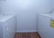 Thumbnail 9 of 21 - a laundry room with a washer and dryer