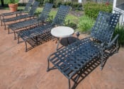 Thumbnail 14 of 21 - a patio with lounge chairs and a table