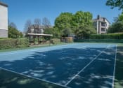Thumbnail 18 of 21 - a tennis court at the whispering winds apartments in pearland, tx