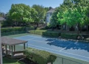 Thumbnail 20 of 21 - a tennis court at the whispering winds apartments in pearland, tx