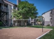 Thumbnail 17 of 21 - a volleyball court at the whispering winds apartments in pearland, tx