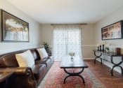 Thumbnail 8 of 35 - a living room with a leather couch and a coffee table