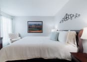 Thumbnail 10 of 35 - a bedroom with a large white bed and a painting on the wall