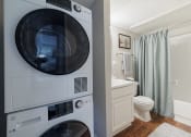 Thumbnail 12 of 35 - a washer and dryer in a bathroom next to a toilet