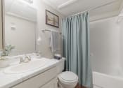 Thumbnail 11 of 35 - a bathroom with a shower and a sink and a toilet