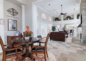 Thumbnail 28 of 35 - a living room and dining room with a table and chairs