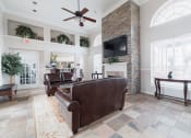 Thumbnail 33 of 35 - a living room with leather furniture and a brick fireplace