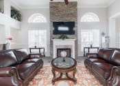 Thumbnail 26 of 35 - a living room with leather couches and a fireplace