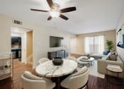 Thumbnail 1 of 18 - a living room with a ceiling fan and a large window