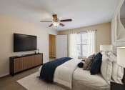 Thumbnail 4 of 18 - a bedroom with a large bed and a ceiling fan