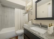 Thumbnail 3 of 18 - a bathroom with a sink toilet and shower