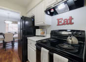 Thumbnail 3 of 32 - a kitchen with a black stove and a black refrigerator
