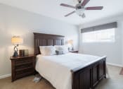 Thumbnail 9 of 32 - a bedroom with a large bed and a ceiling fan