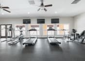 Thumbnail 26 of 32 - the gym with treadmills and weights at the apartments