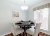Thumbnail 5 of 32 - a dining room with a table and chairs and a large window