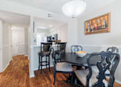 Thumbnail 8 of 54 - A dining room with a table set for two.