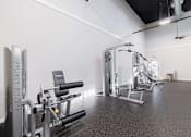Thumbnail 27 of 54 - A gym with a variety of equipment including a leg press machine.