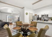 Thumbnail 7 of 43 - A modern dining room with a glass table and chairs.
