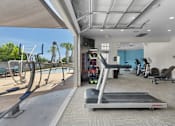 Thumbnail 39 of 43 - A treadmill is in the middle of a room with exercise equipment.