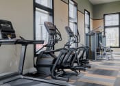 Thumbnail 32 of 43 - a row of treadmills and exercise machines in a fitness room