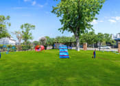 Thumbnail 14 of 16 - a large grassy area with a swing set and other playground equipment