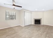 Thumbnail 3 of 16 - a living room with a fireplace and a ceiling fan